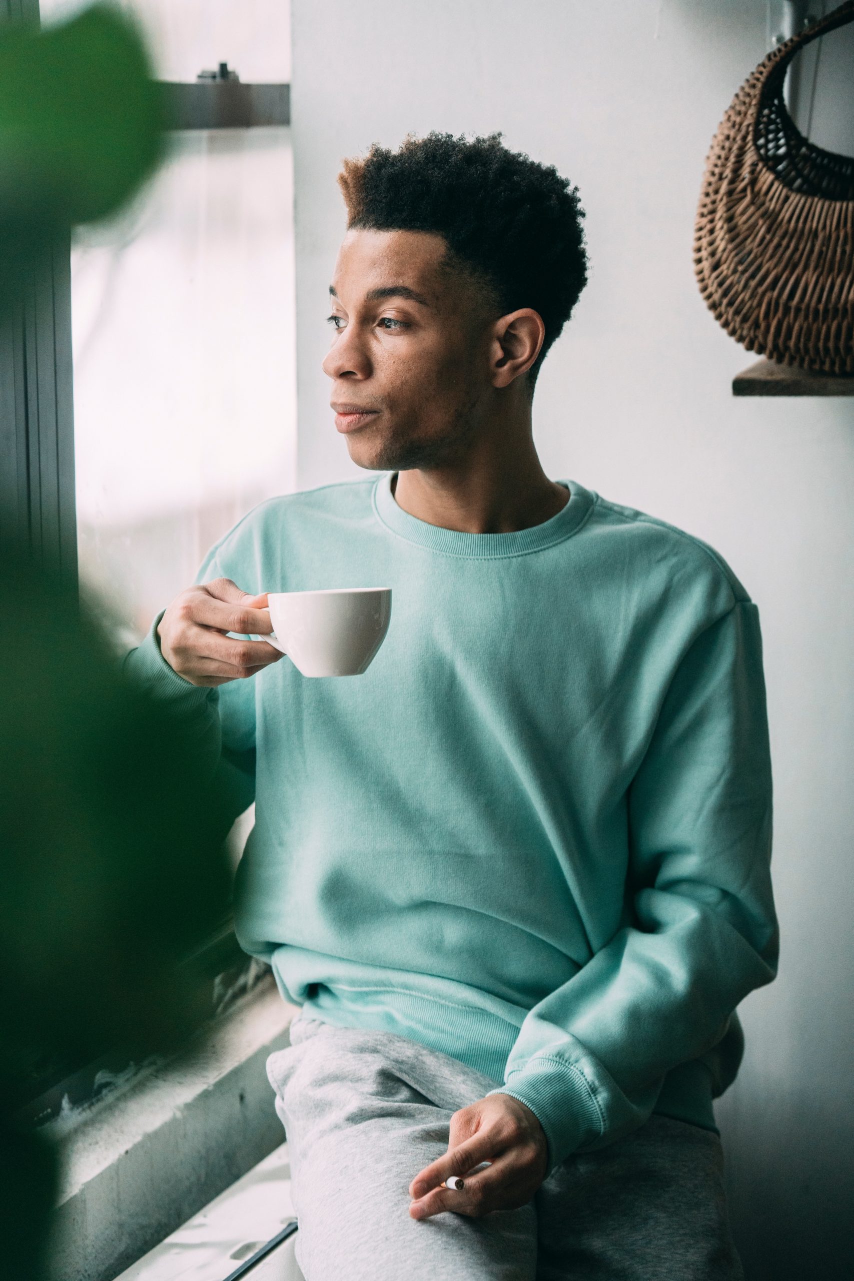 Photo by Greta Hoffman : https://www.pexels.com/photo/thoughtful-black-man-with-cigarette-drinking-coffee-near-window-7674861/